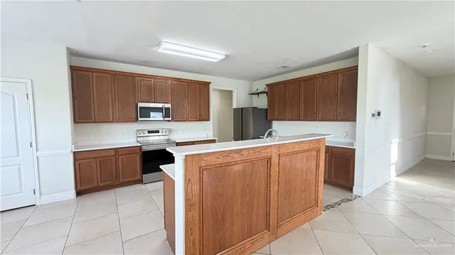 a kitchen with stainless steel appliances a refrigerator sink and microwave