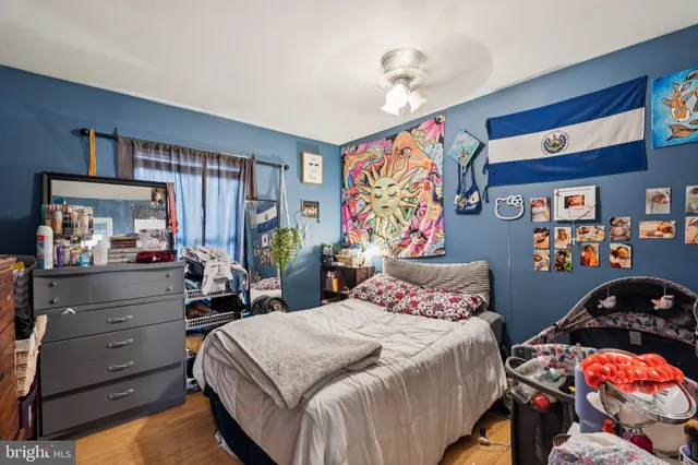 a bedroom with bed and dresser