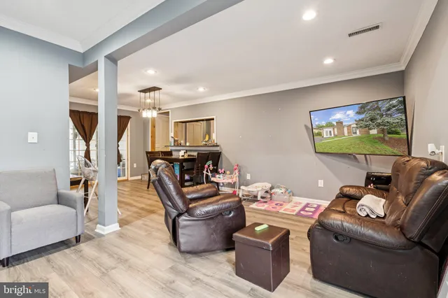 a living room with furniture a ceiling fan and a rug