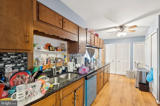a kitchen filled with stainless steel appliances kitchen island granite countertop a sink and cabinets