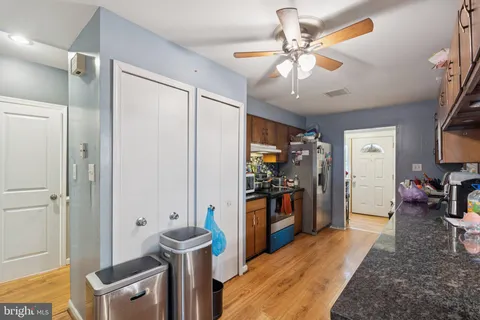 a view of a kitchen with refrigerator and workspace