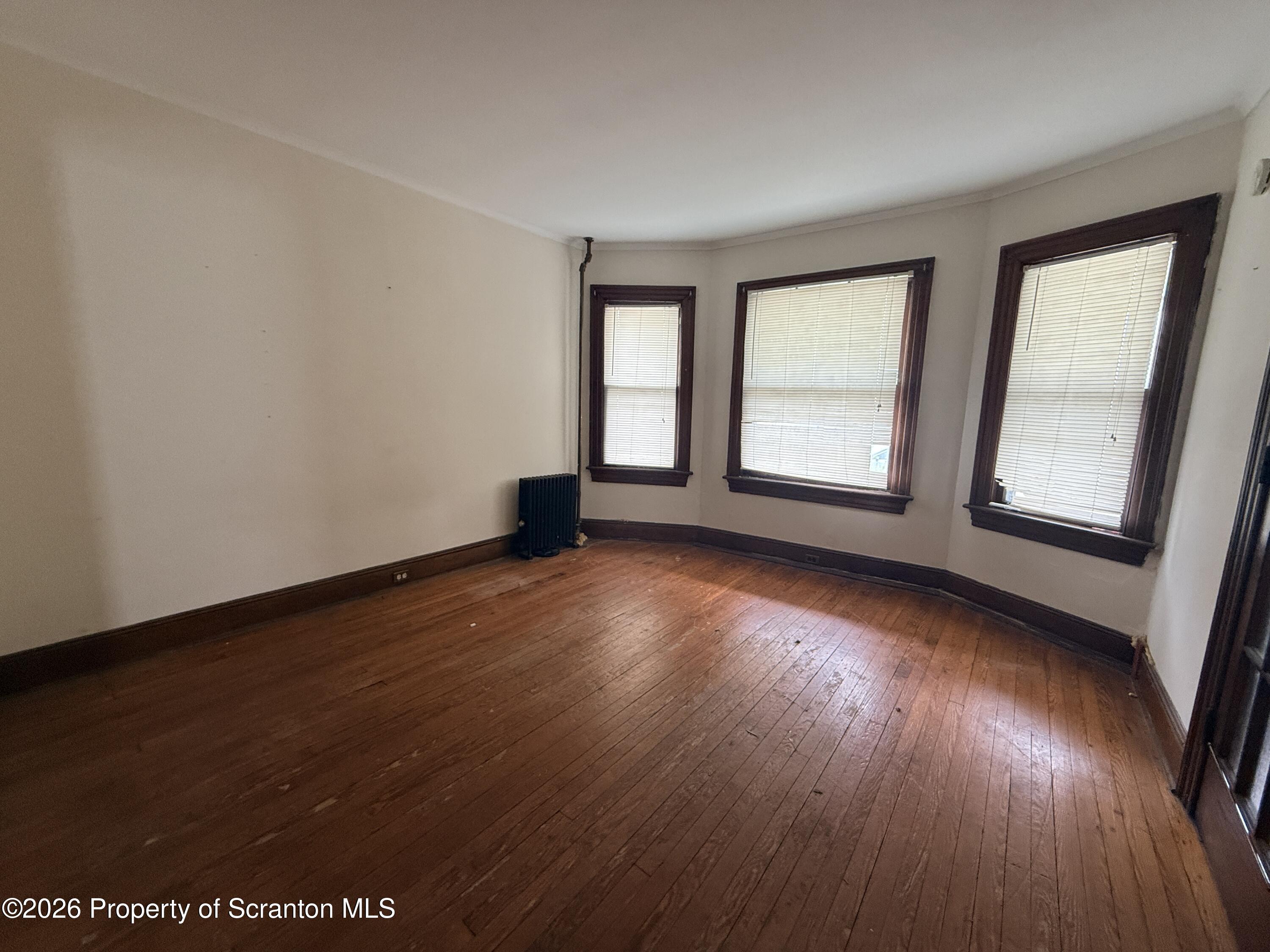 2045 Edna Avenue Scranton, PA 18508 - Photo 14 of 44 an empty room with wooden floor and windows