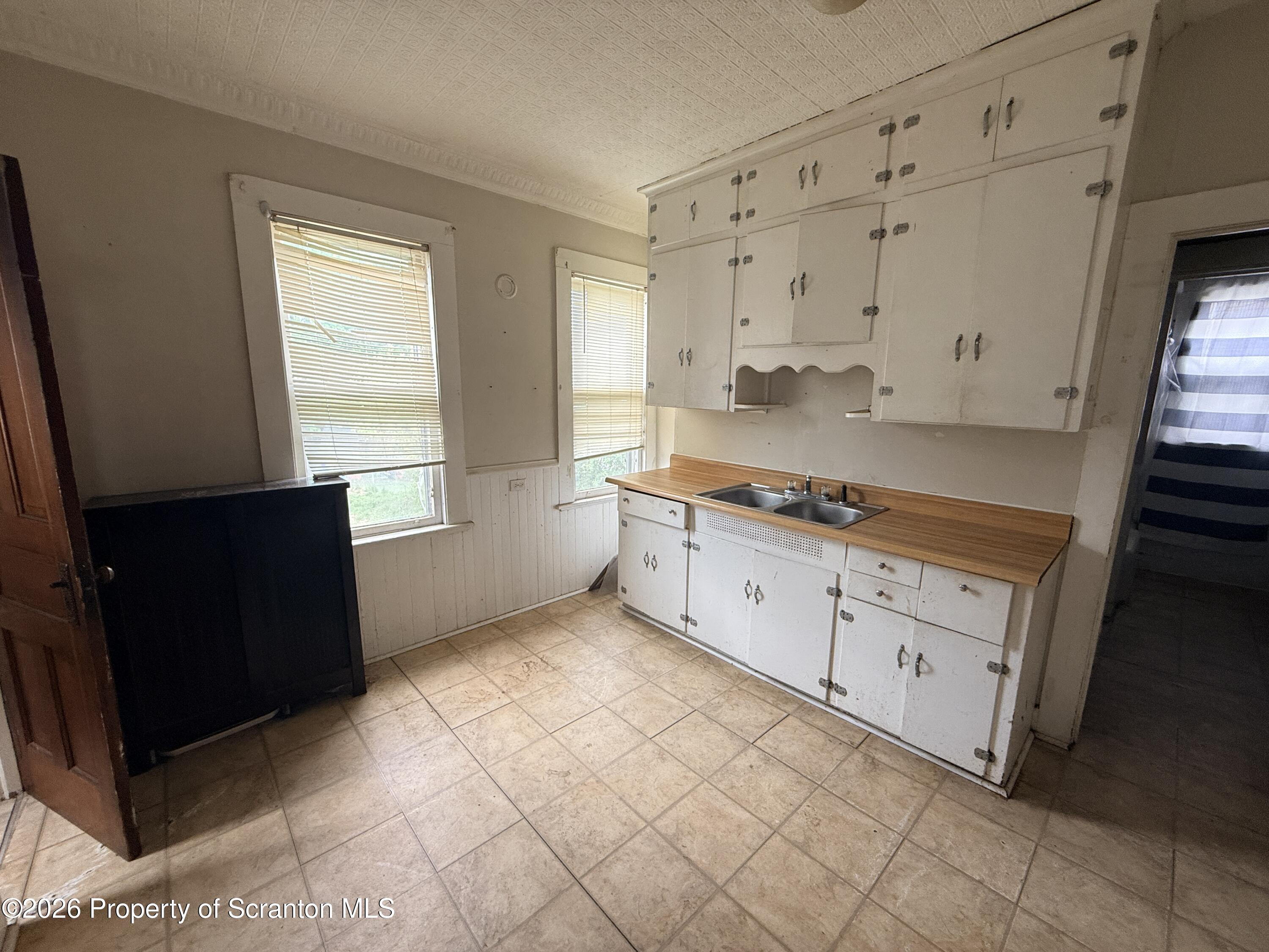 2045 Edna Avenue Scranton, PA 18508 - Photo 19 of 44 a kitchen with granite countertop white cabinets and window