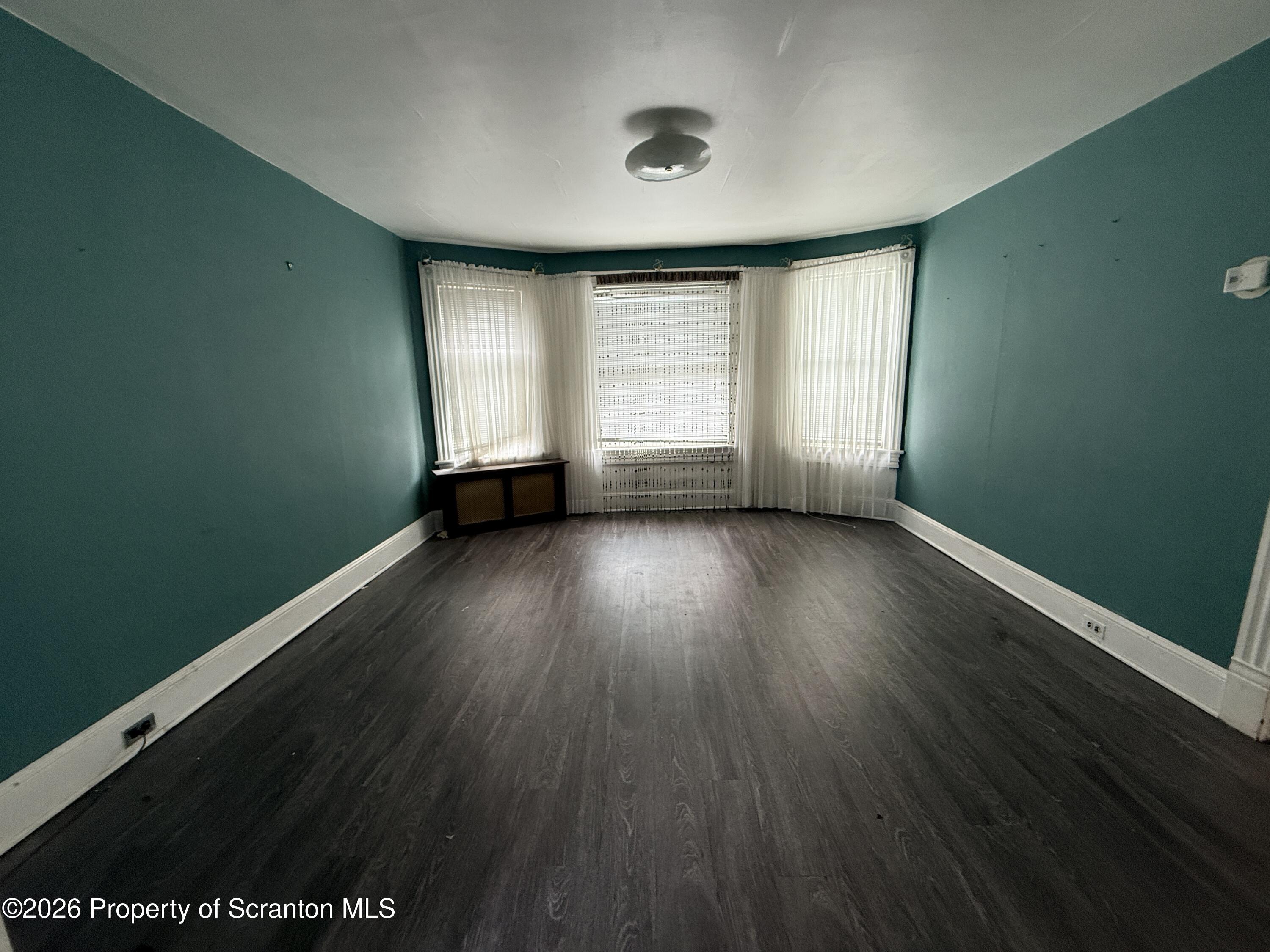 2045 Edna Avenue Scranton, PA 18508 - Photo 26 of 44 an empty room with wooden floor and windows