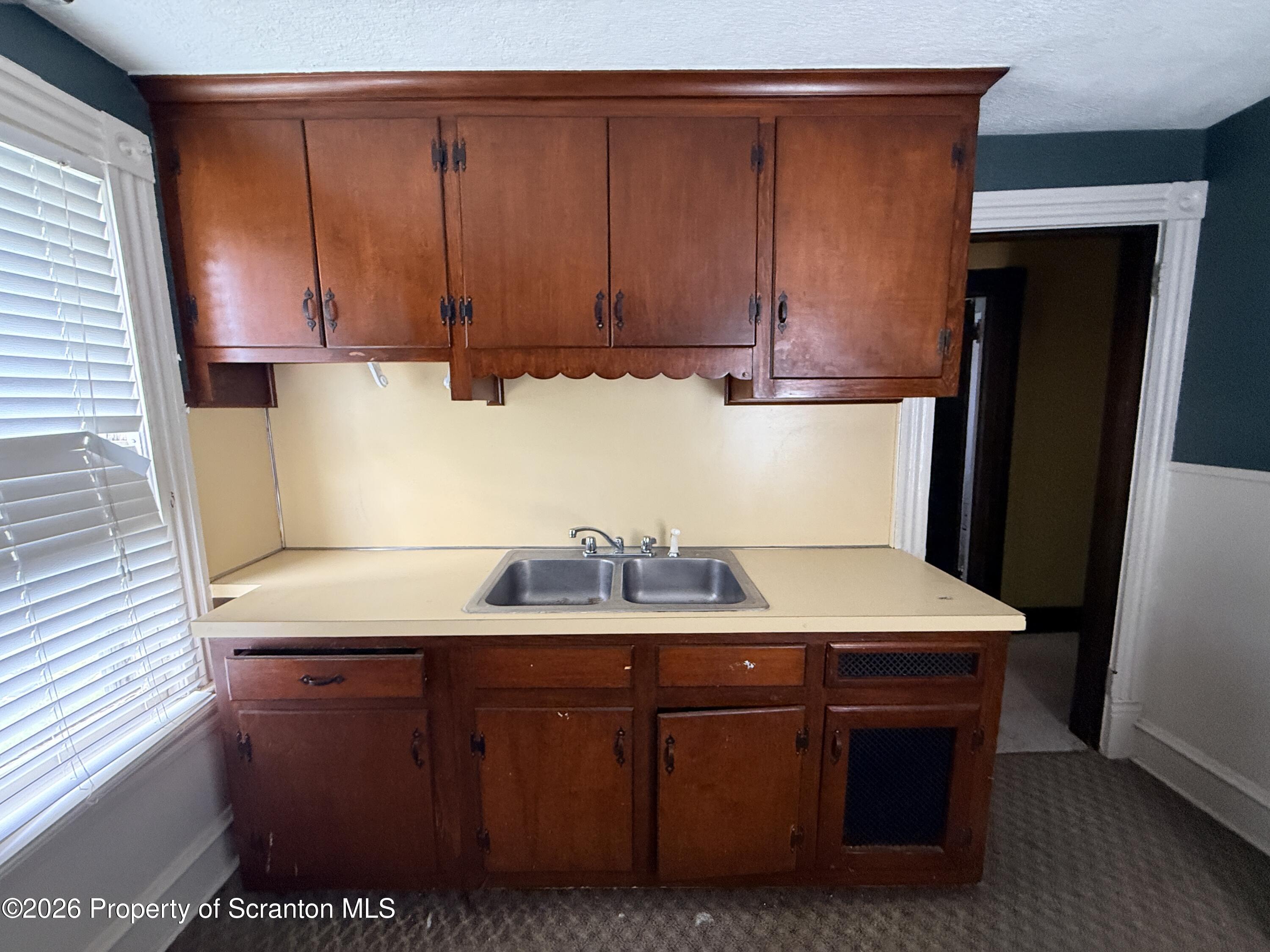 2045 Edna Avenue Scranton, PA 18508 - Photo 30 of 44 a kitchen with a sink a refrigerator and cabinets