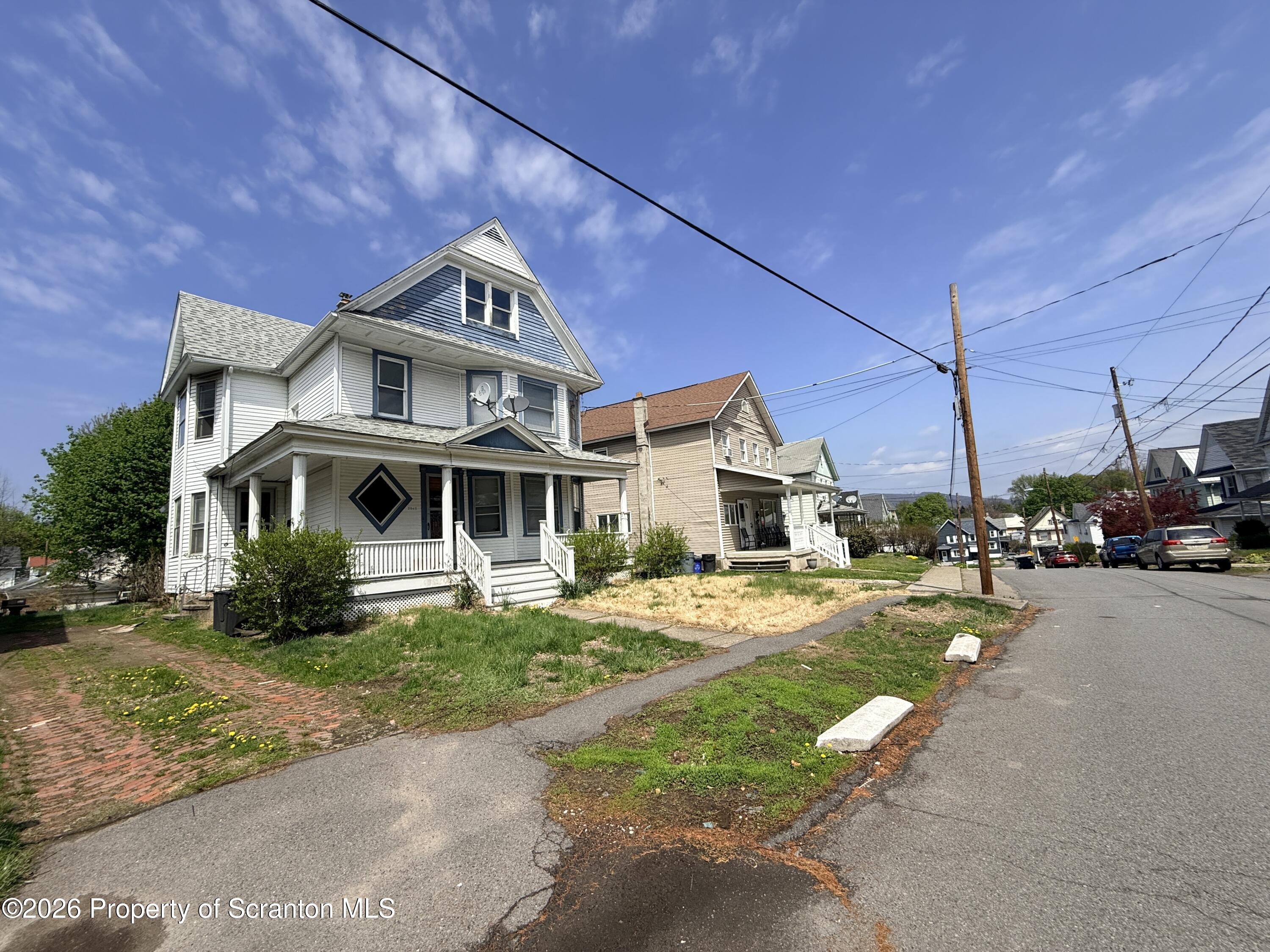 2045 Edna Avenue Scranton, PA 18508 - Photo 4 of 44 a front view of a house with a garden and deck