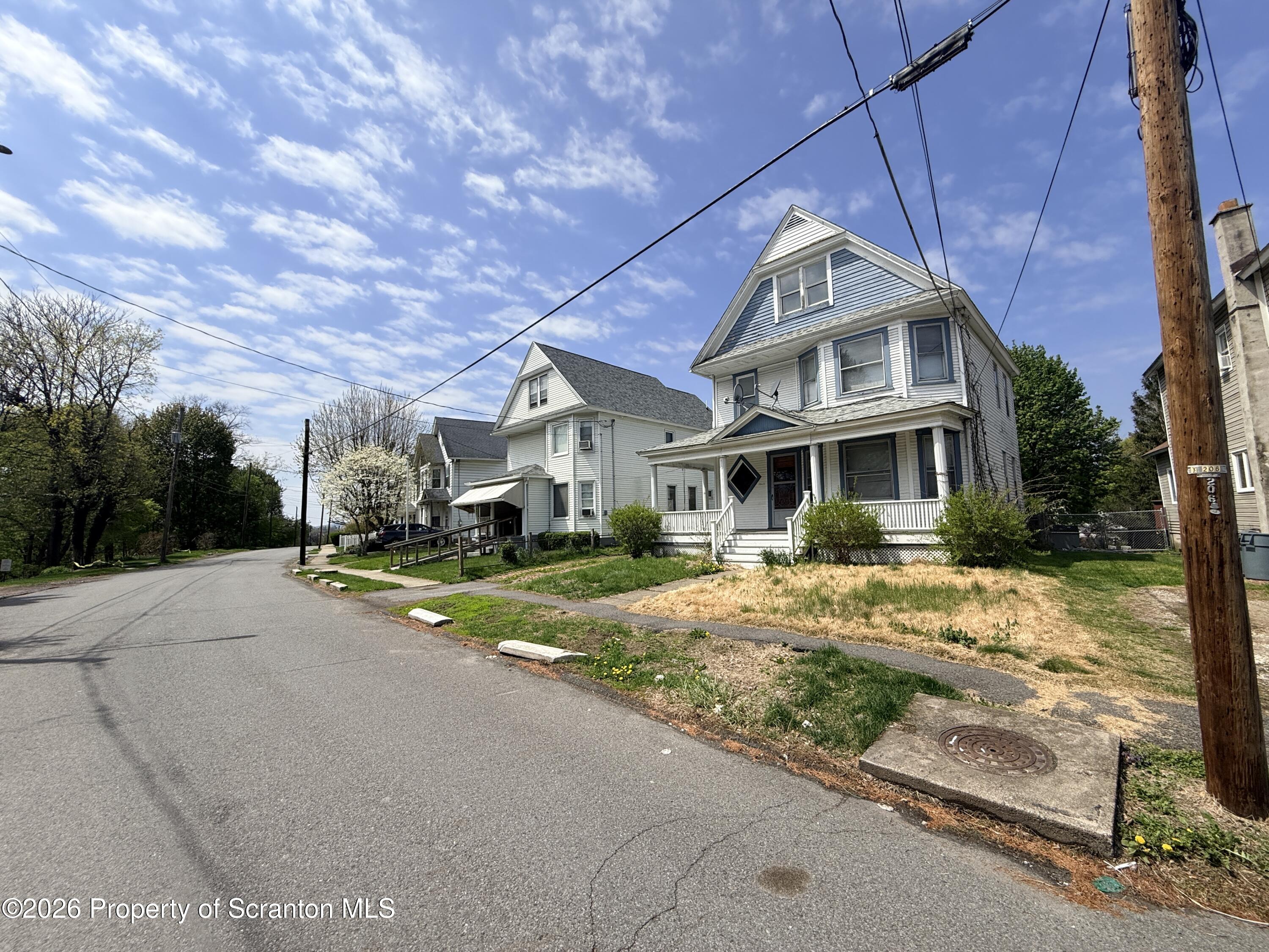 2045 Edna Avenue Scranton, PA 18508 - Photo 6 of 44 a front view of a house with a yard