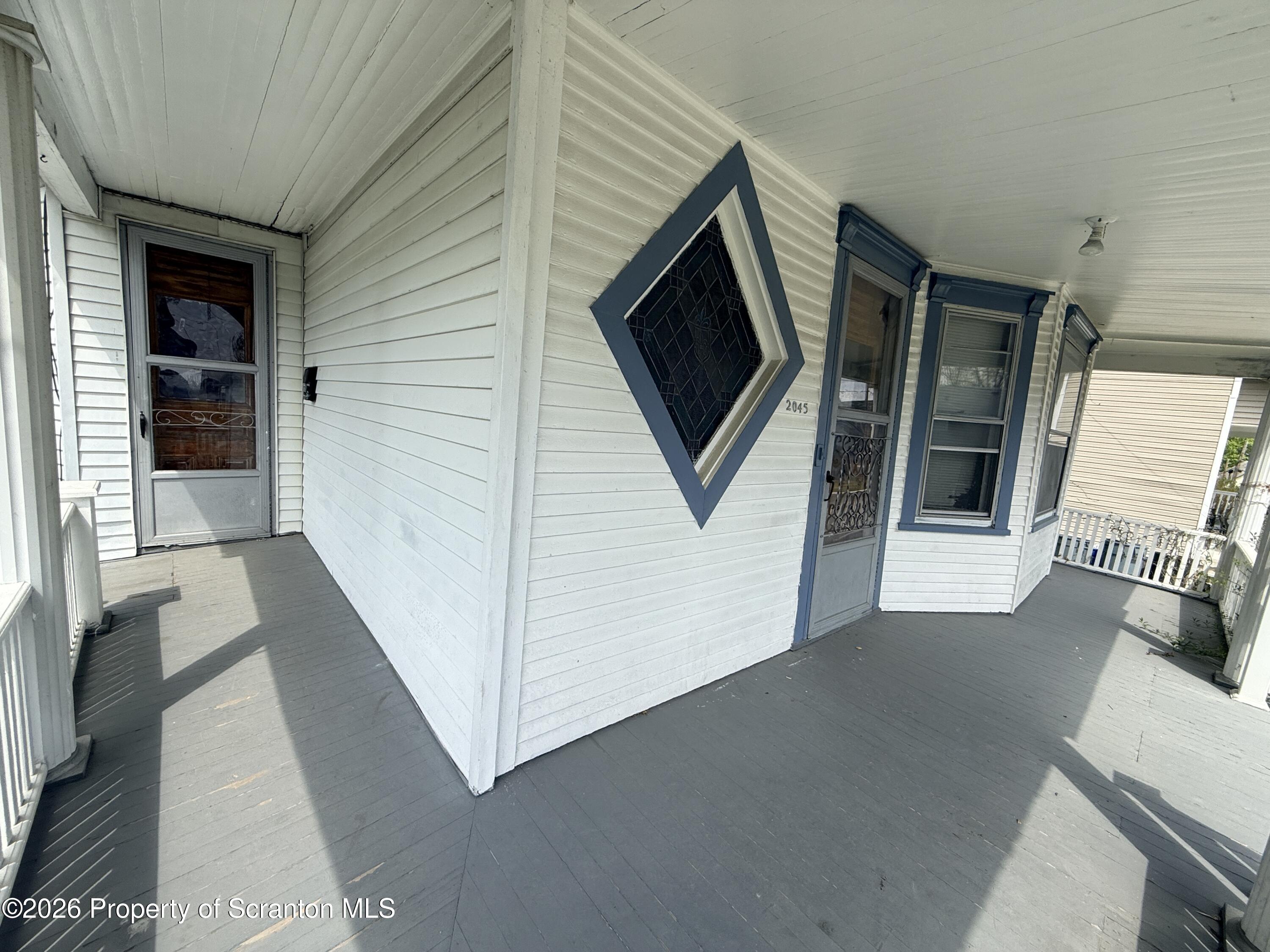 2045 Edna Avenue Scranton, PA 18508 - Photo 8 of 44 a view of a hallway with wooden floor and windows
