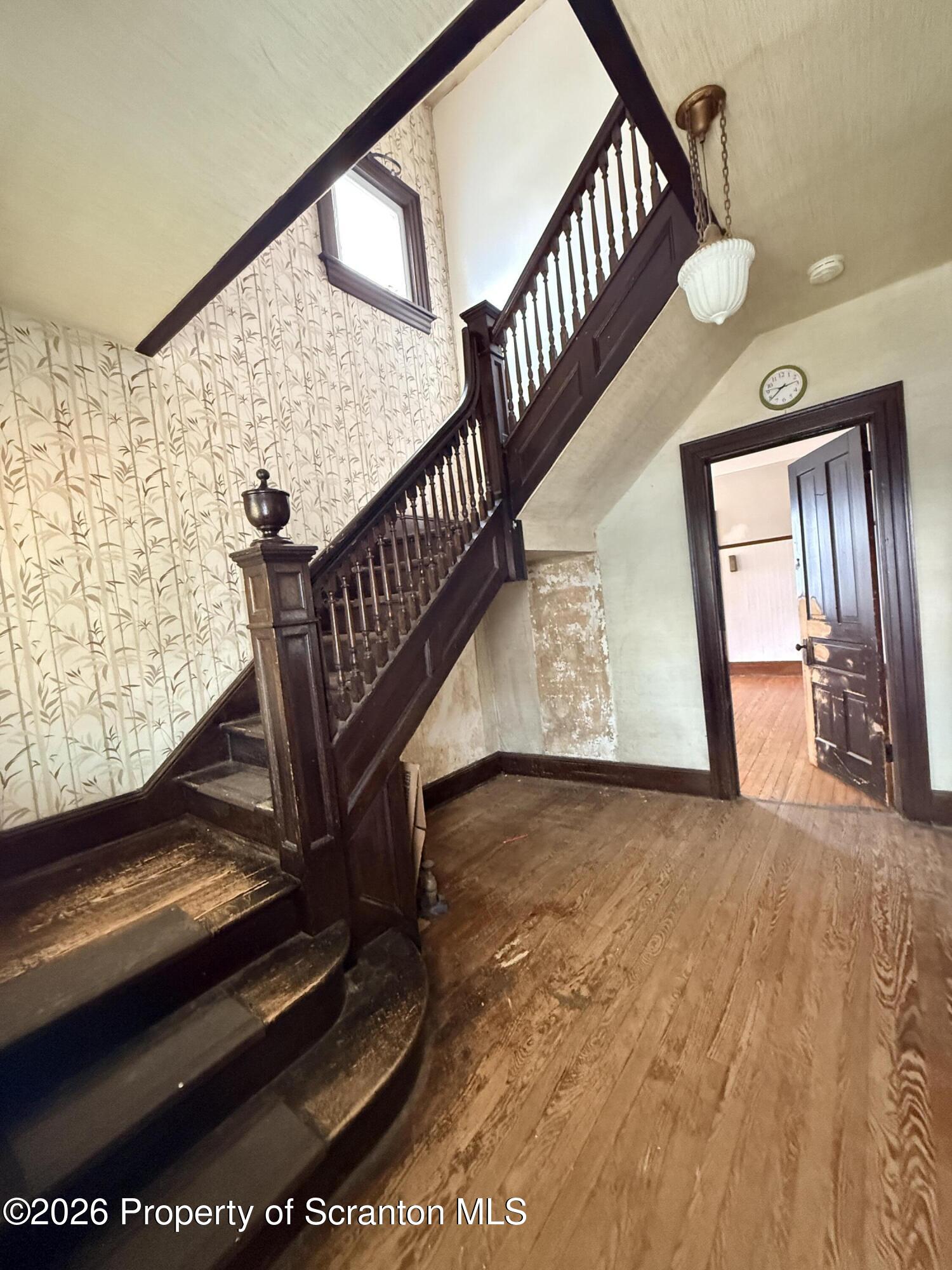 2045 Edna Avenue Scranton, PA 18508 - Photo 10 of 44 a view of staircase with wooden floor and a rug