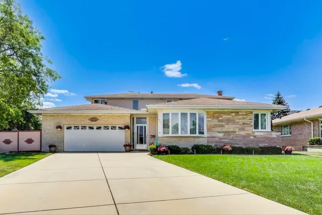 a front view of a house with a garden