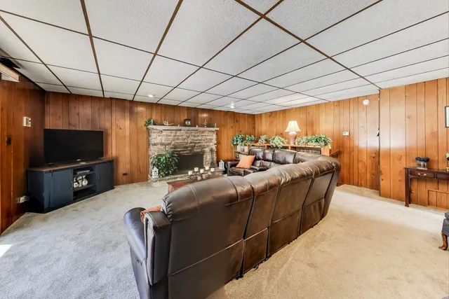 a living room with furniture a fireplace and potted plants