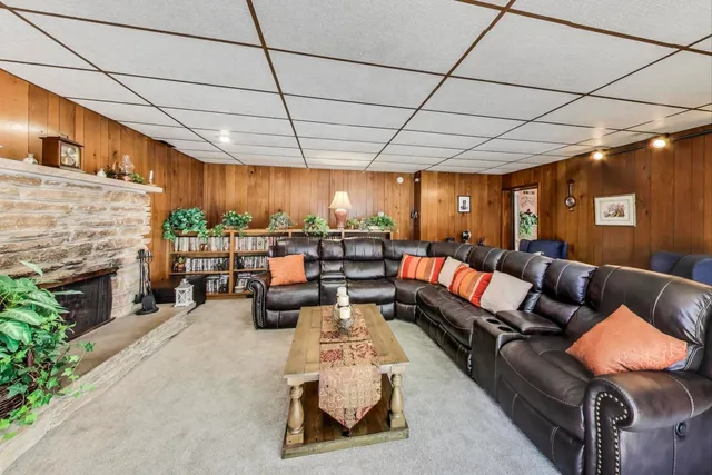 a living room with furniture a flat screen tv and a large window