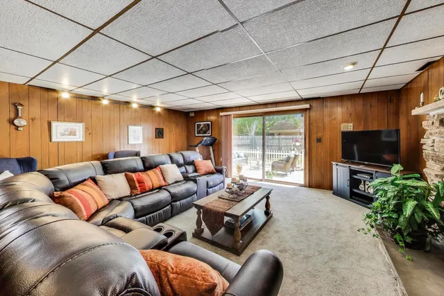 a bedroom with furniture and a book shelf