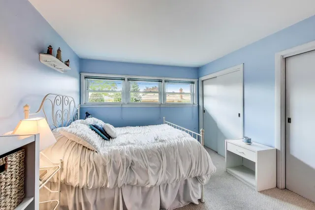 a bedroom with furniture and a flat screen tv
