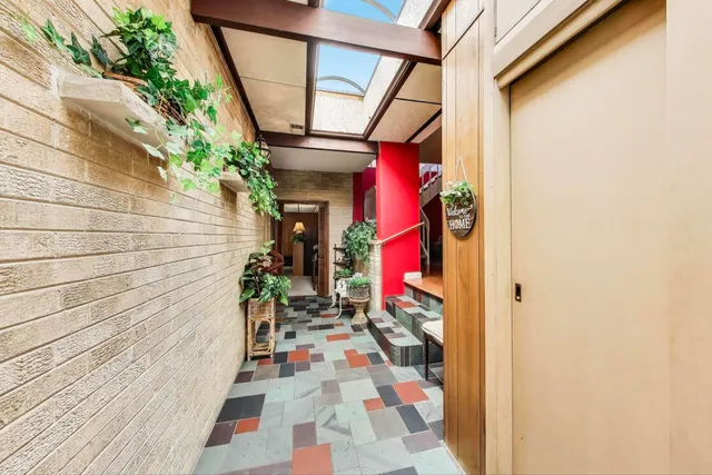 a view of a pathway with flower pots