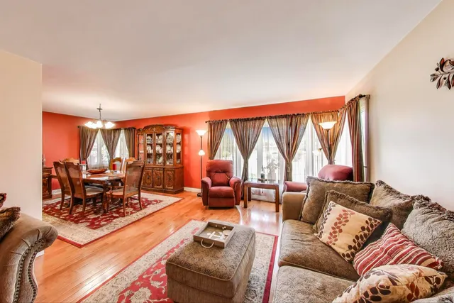 a living room with furniture a rug and a lamp
