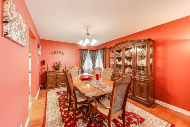 a large kitchen with stainless steel appliances kitchen island a large counter top a stove a refrigerator cabinets and living room view