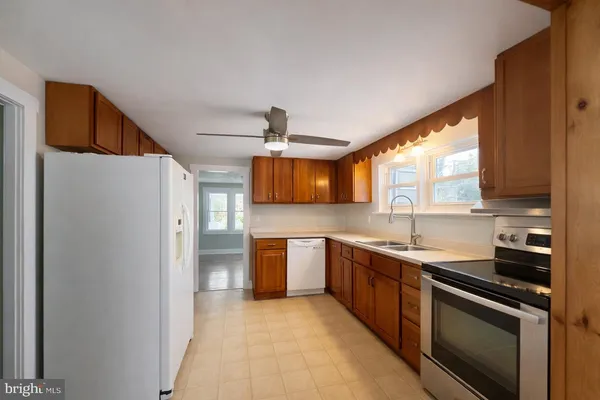 a kitchen with stainless steel appliances a sink stove and refrigerator