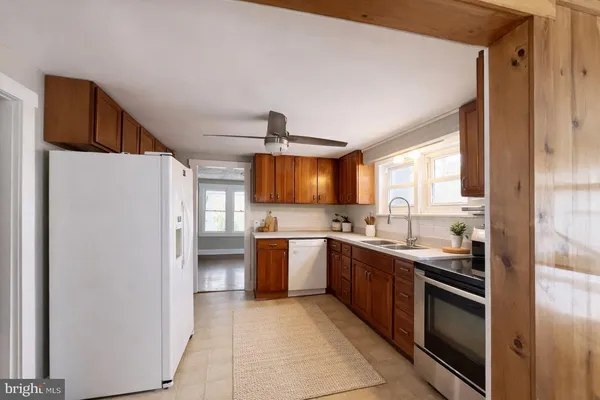 a kitchen with stainless steel appliances a stove sink and refrigerator