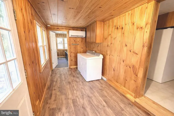a view of a room with a window and wooden floor
