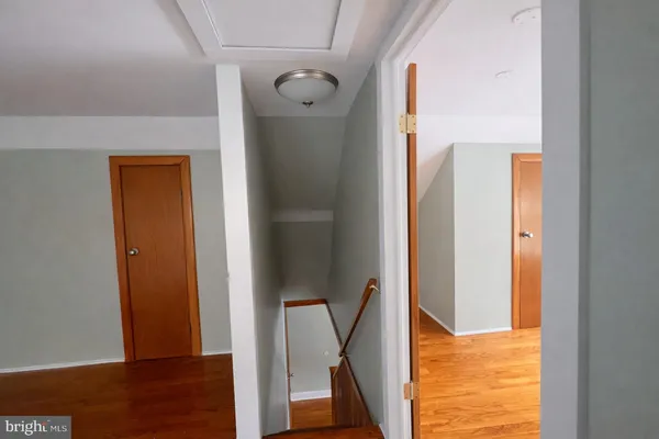 a view of a hallway with wooden floor