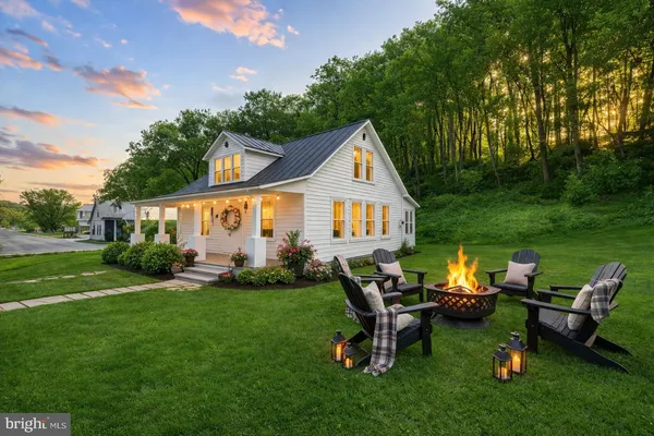 a view of a house with a yard and sitting area