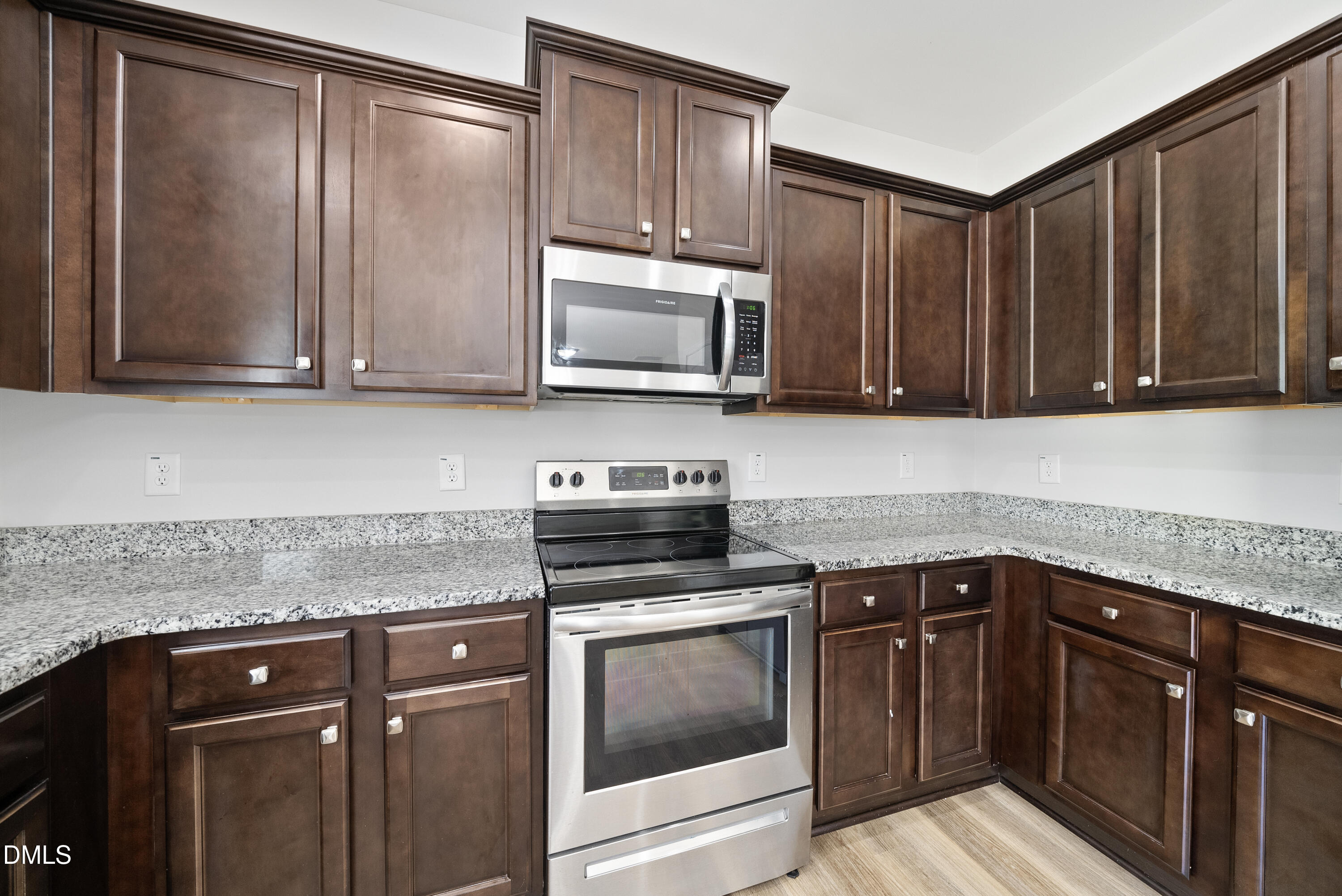 2816 Elsa Drive Raleigh, NC 27610 - Photo 18 of 35 a kitchen with granite countertop wood cabinets and stainless steel appliances