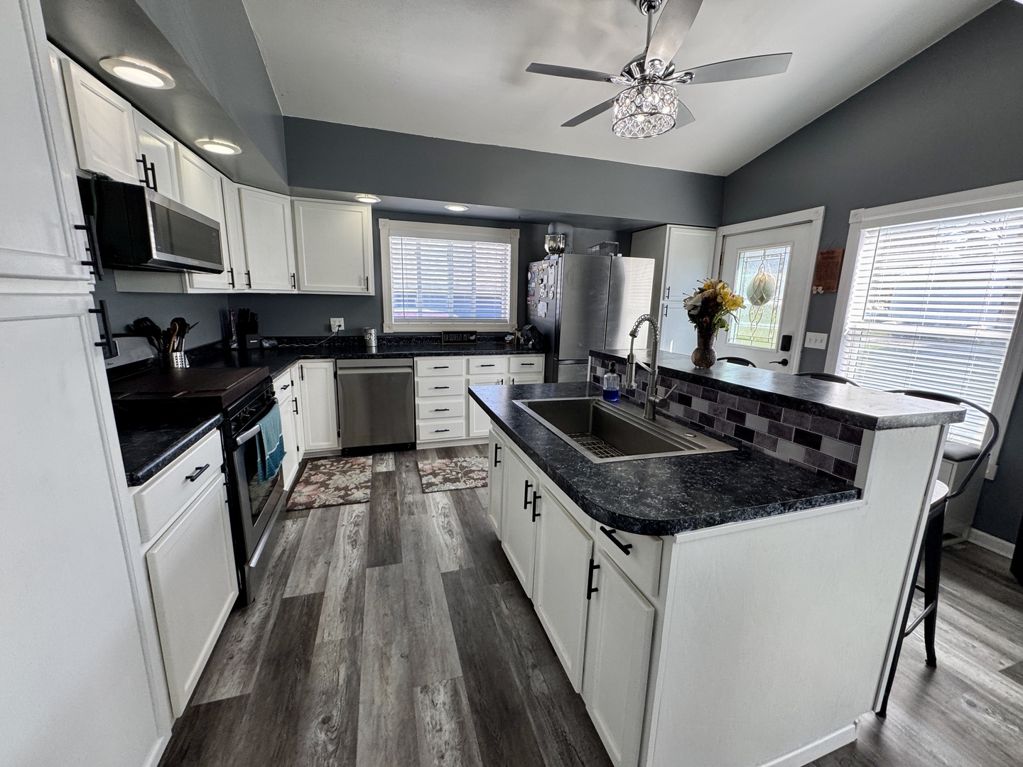304 South Church Street Sheffield, IL 61361 - Photo 6 of 23 a kitchen with a sink stove and microwave