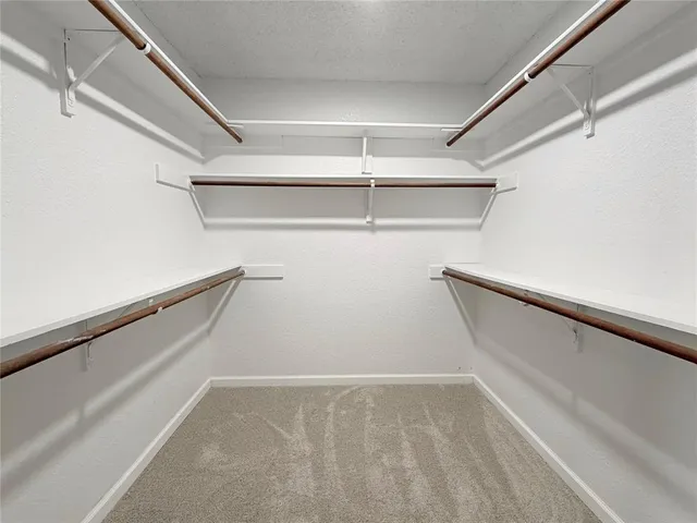 a bathroom with a granite countertop sink toilet and mirror