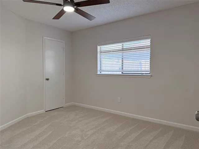 a view of a yard with wooden fence