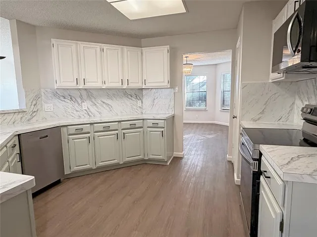 a kitchen with a sink stove and cabinets