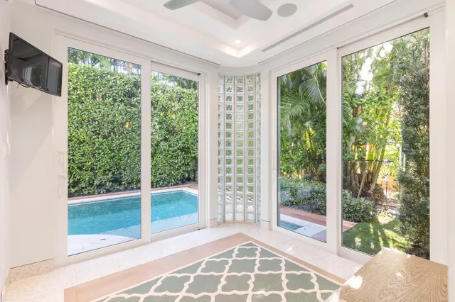 a view of an empty room with wooden floor and garden