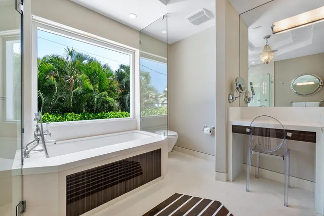 a bathroom with a sink a large mirror and a shower
