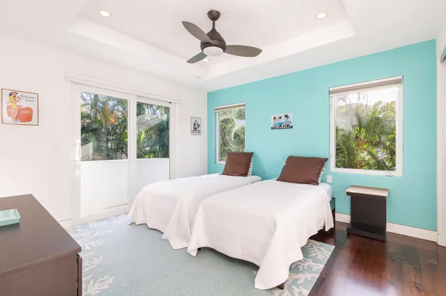 a bedroom with a bed chandelier and a window