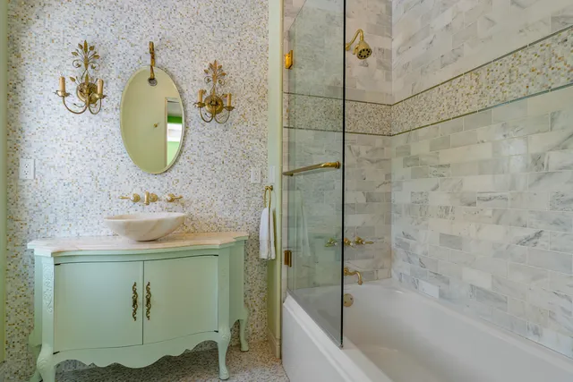 a bathroom with a sink mirror and bathtub