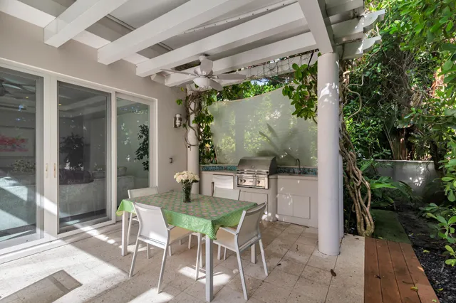 a patio with yard glass top table and chairs