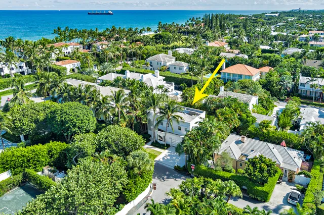 an aerial view of residential houses with outdoor space and trees all around