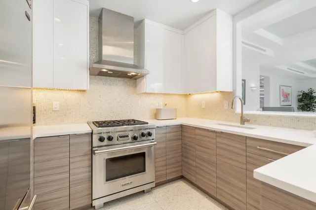 a kitchen with cabinets appliances and a sink