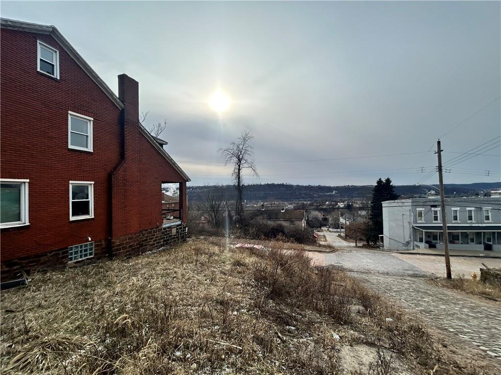 553 Price Avenue Braddock, PA 15104 - Photo 3 of 15 a backyard of a house with shaded area