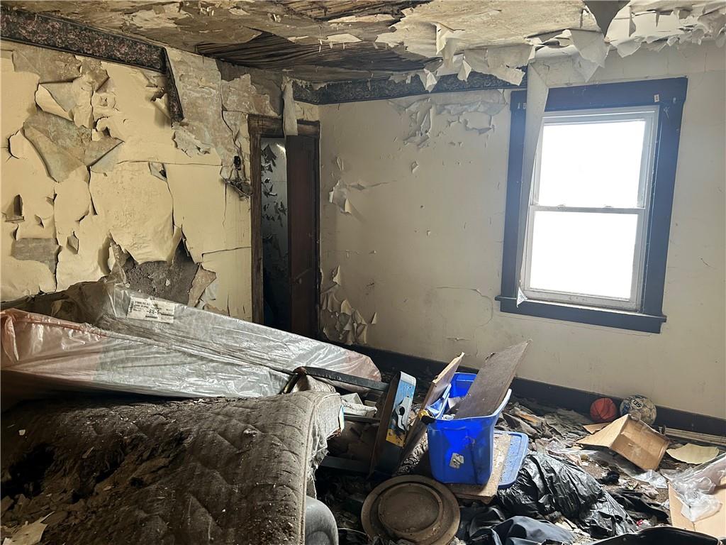 553 Price Avenue Braddock, PA 15104 - Photo 9 of 15 a room with a bed and dresser