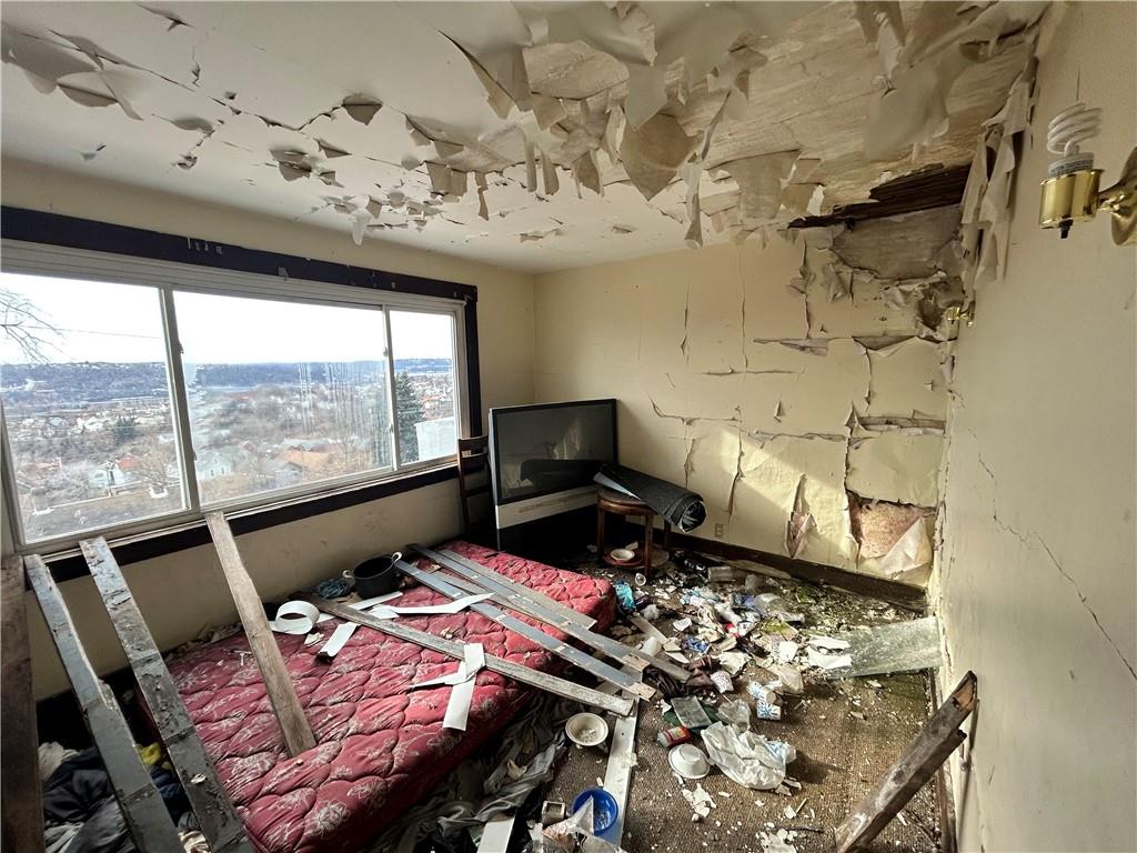 553 Price Avenue Braddock, PA 15104 - Photo 10 of 15 a bedroom with bed and wooden floor