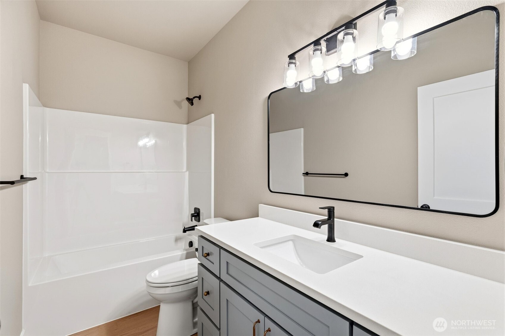 254 Windy Ridge Drive Longview, WA 98632 - Photo 9 of 27 a bathroom with a sink a toilet a mirror a vanity and bathtub