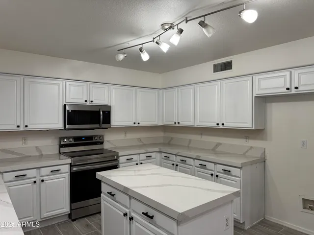 a kitchen with a sink stove and microwave