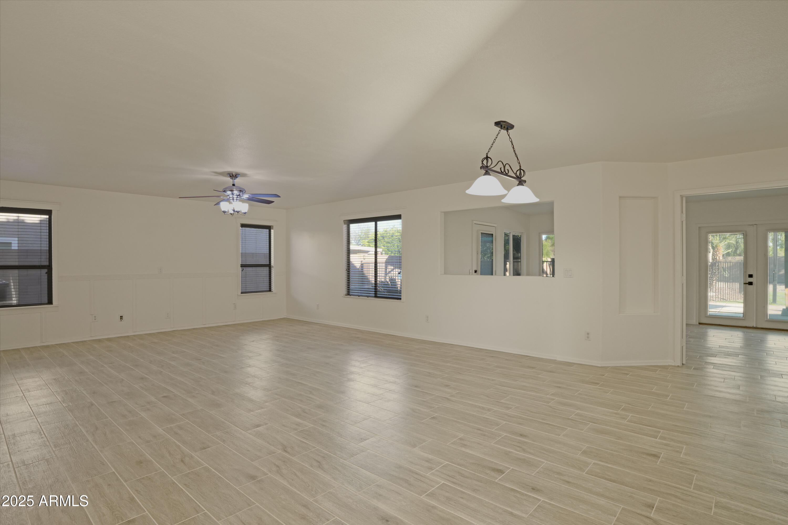 15727 West Rimrock Street Surprise, AZ 85374 - Photo 13 of 29 wooden floor in an empty room with a window