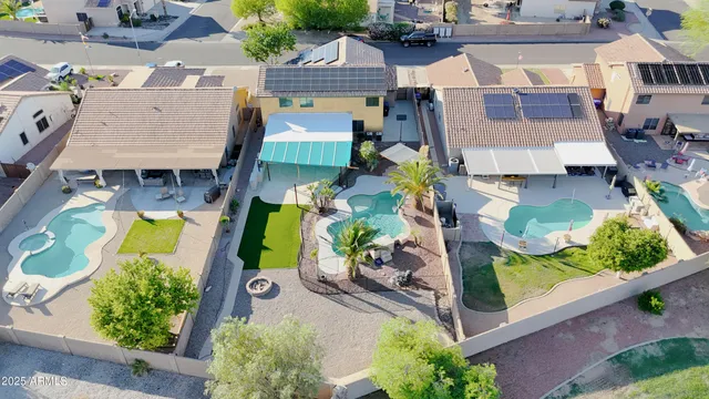 an aerial view of residential houses with yard