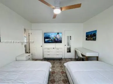 a bedroom with a bed and dresser