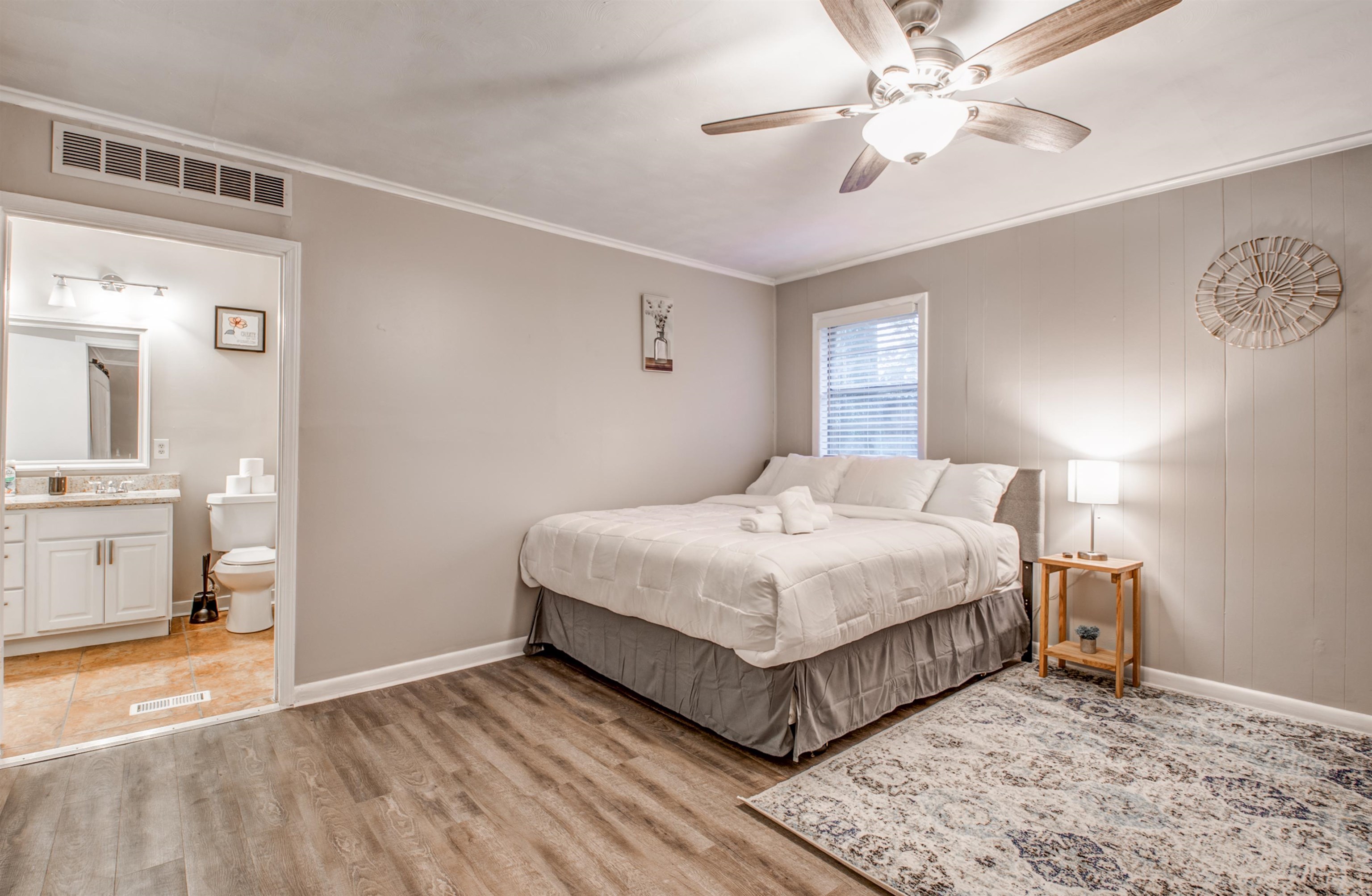 4850 Flamingo Road Memphis, TN 38117 - Photo 22 of 40 Bedroom with light wood-style floors, ceiling fan, ornamental molding, and connected bathroom