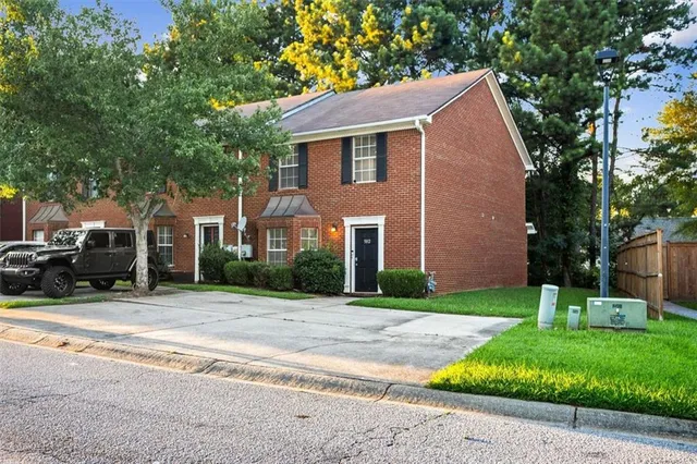a front view of house with yard and green space