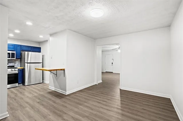 a view of kitchen with stainless steel appliances a refrigerator and a stove top oven