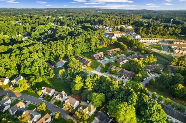 a view of a city with lush green forest
